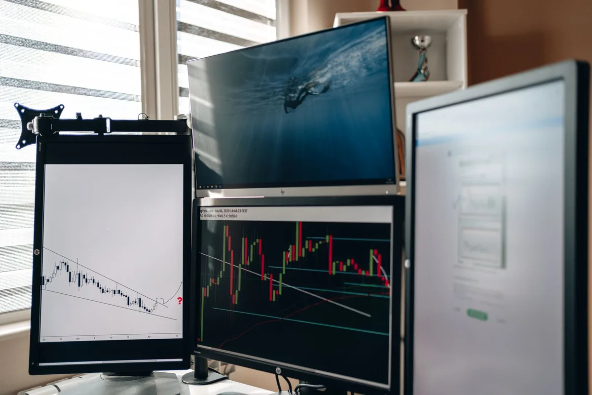 Multiple market data screens displaying international investment indices and financial analytics
