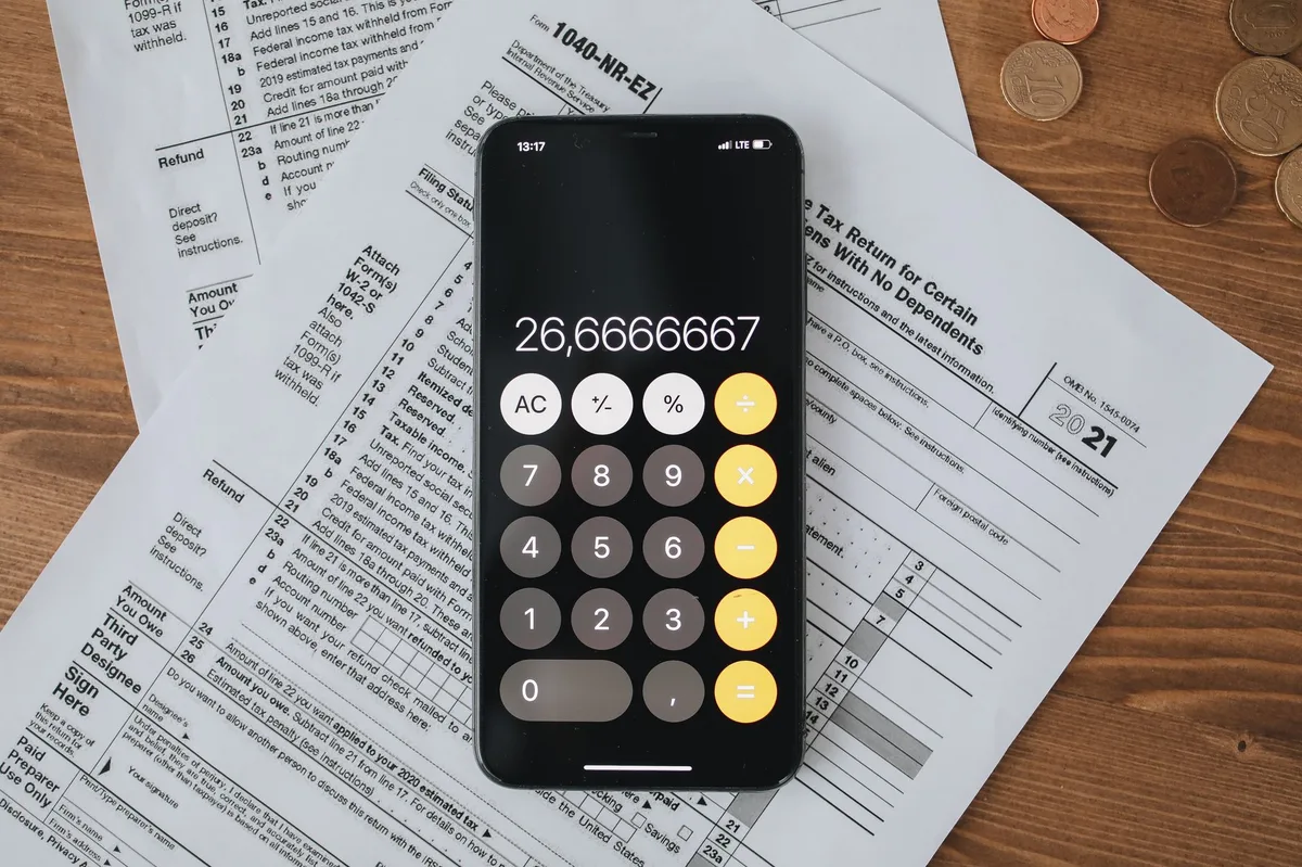 Calculator resting on tax documents and financial paperwork