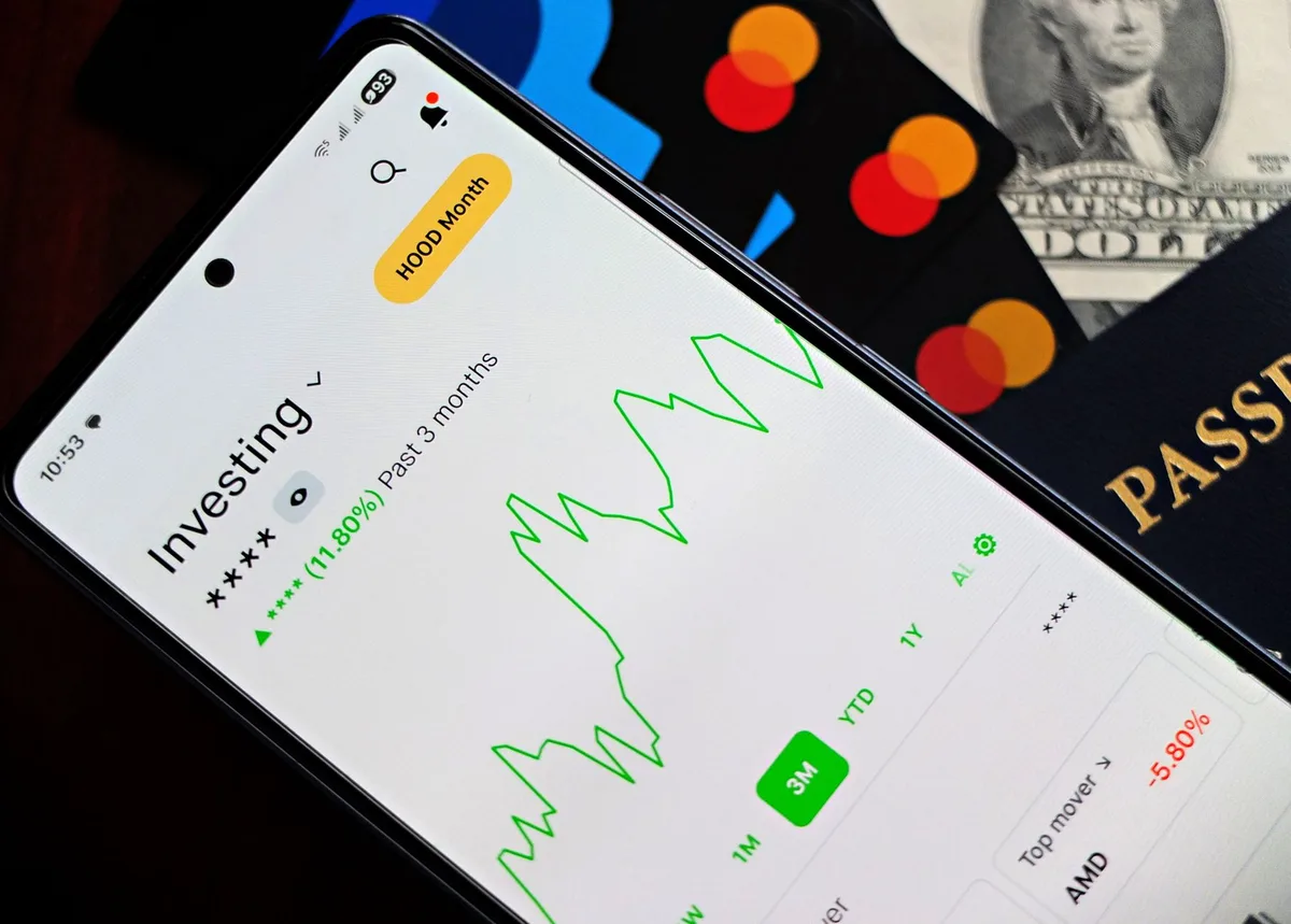 Smartphone displaying investment portfolio app with financial charts and analytics