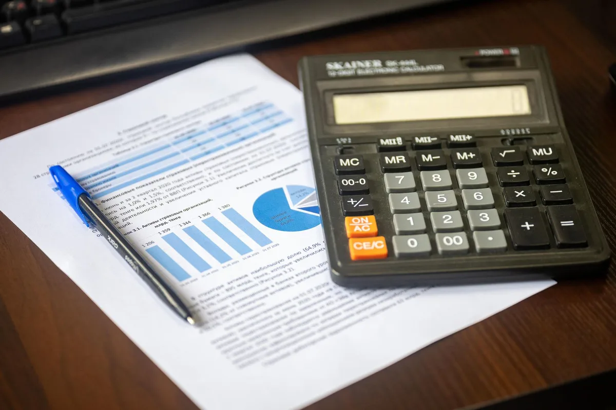 Financial planning documents and calculator on desk representing superannuation and mortgage offset decision