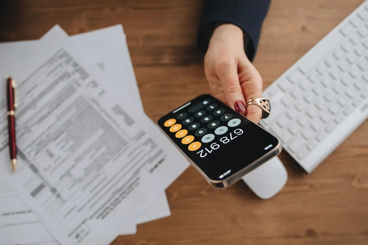 Calculator resting on tax documents and financial papers