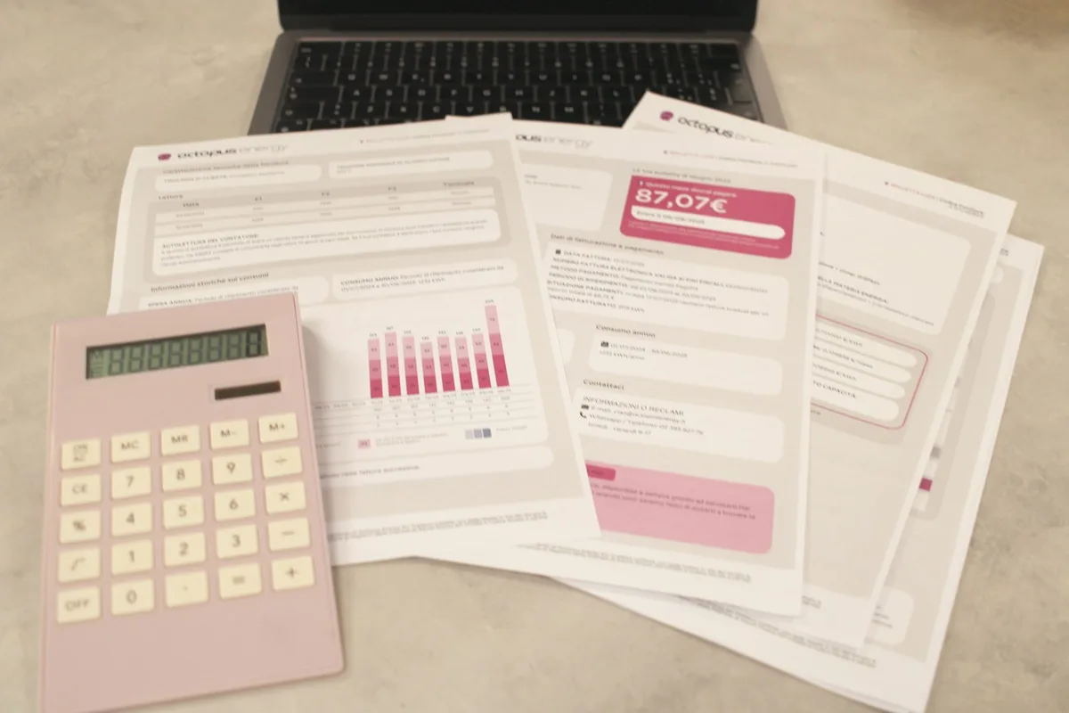 Calculator resting on financial documents and tax forms