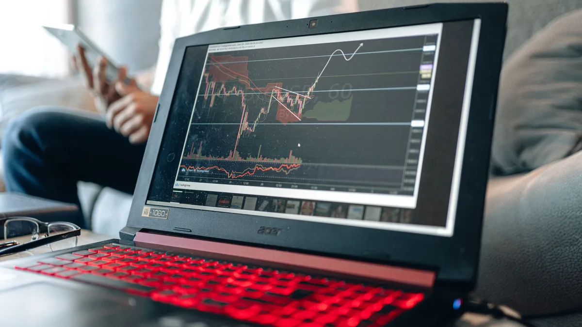 Financial graphs and market charts displayed on laptop screen for investment analysis