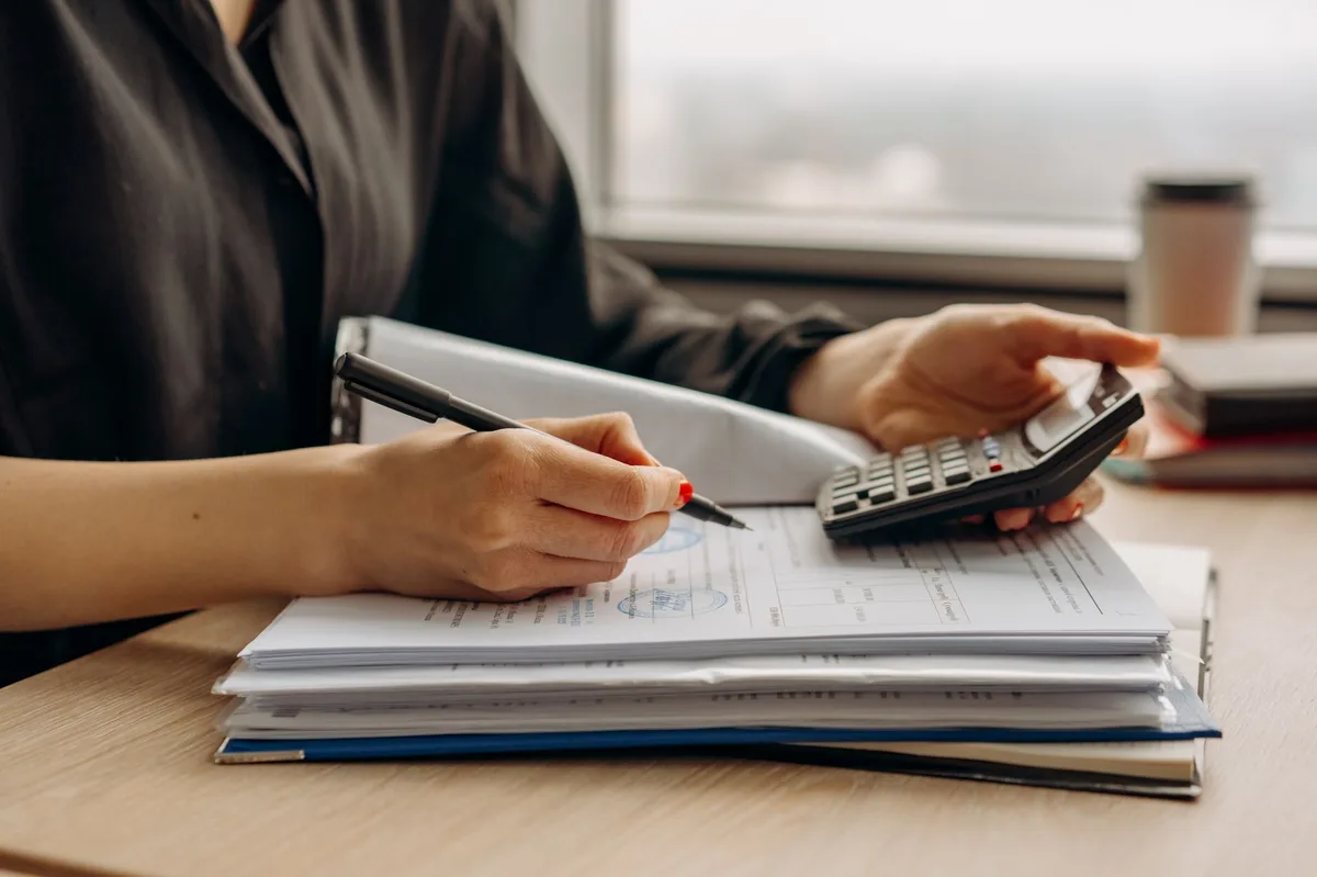 Financial planning documents and pen on wooden desk representing RRSP contribution planning