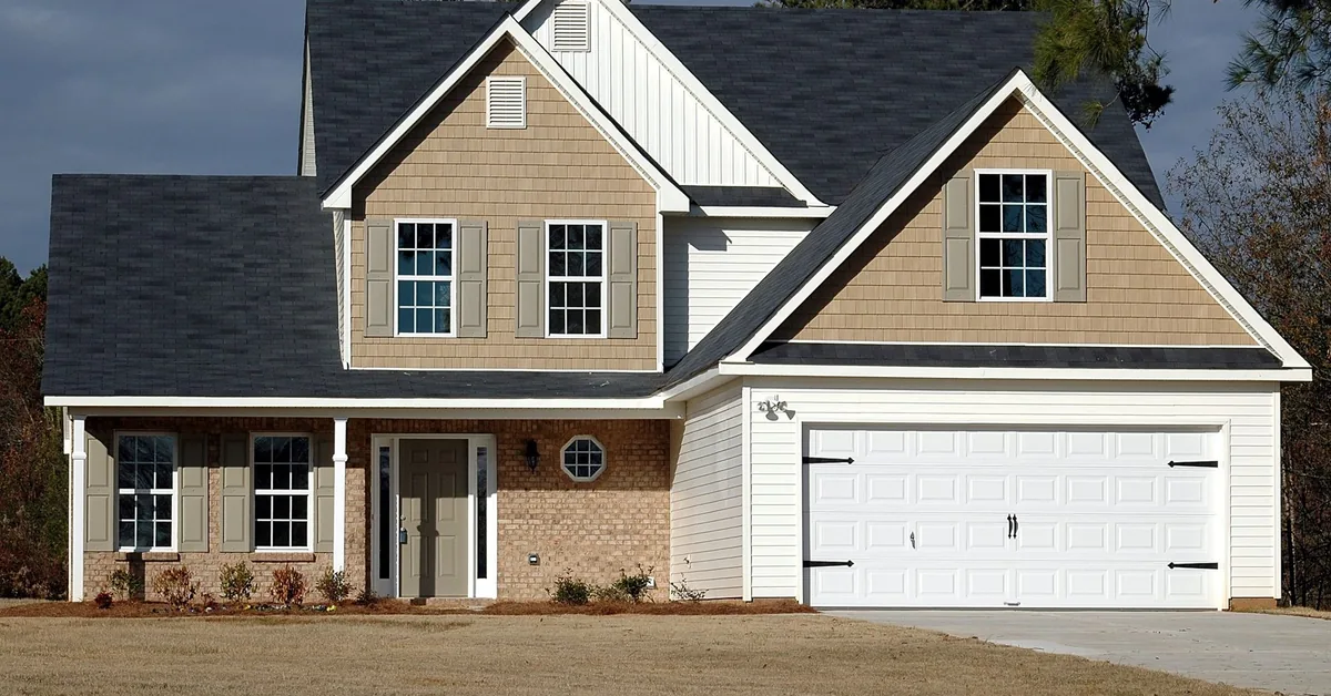 Person holding house keys during mortgage signing process