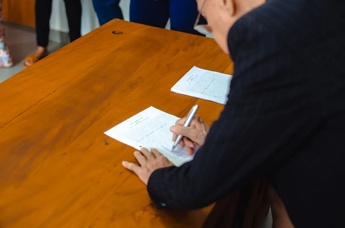 Documents and pen on desk representing financial planning and protection against scams