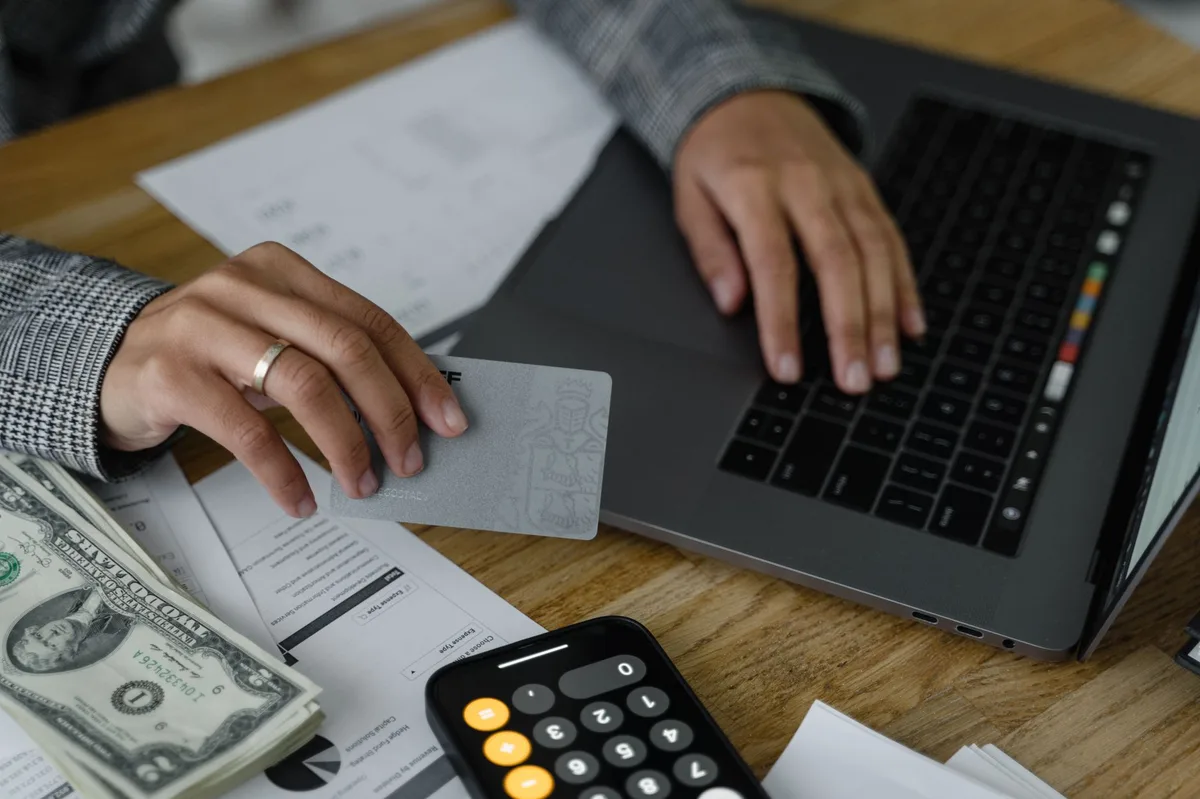 Calculator on financial documents representing debt repayment planning