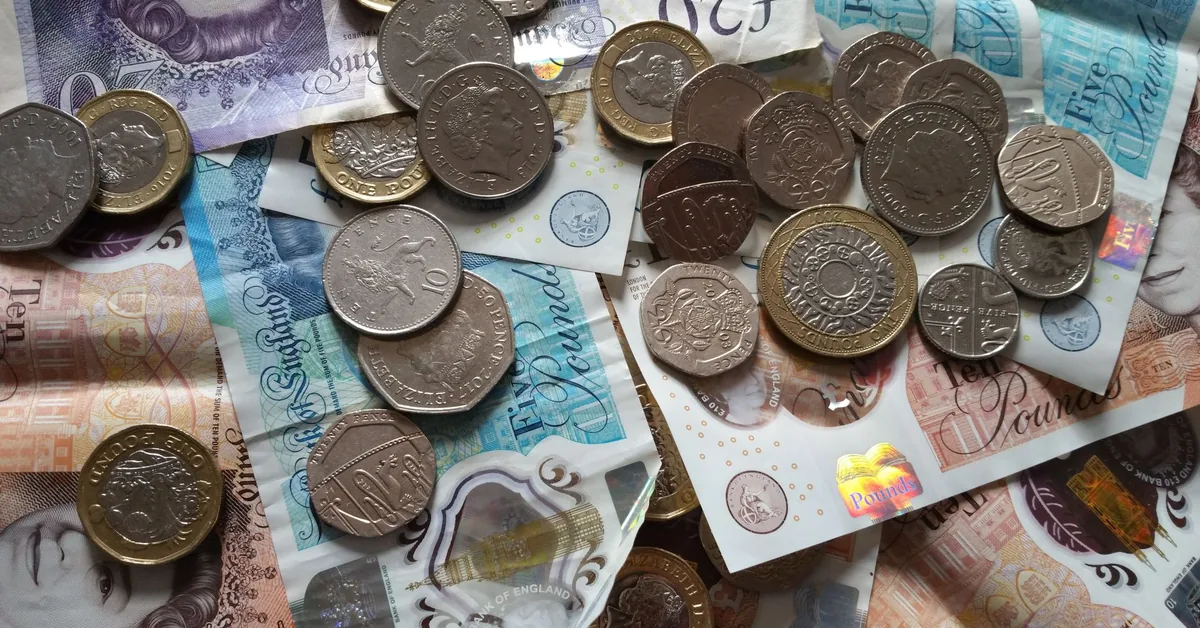 A piggy bank and savings paperwork on a desk, representing ISA planning in the UK