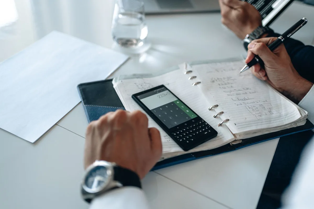 Planning desk with notebook and calculator for pension contributions