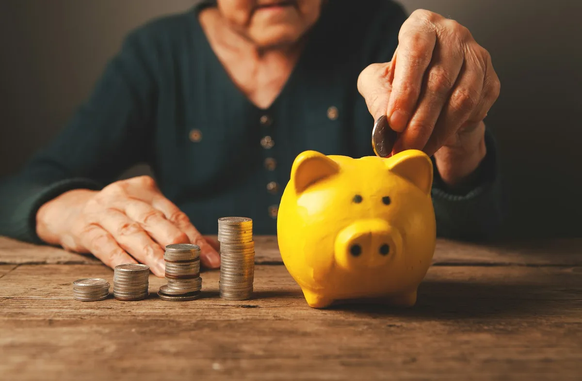Piggy bank with stacked coins representing Cash ISA savings