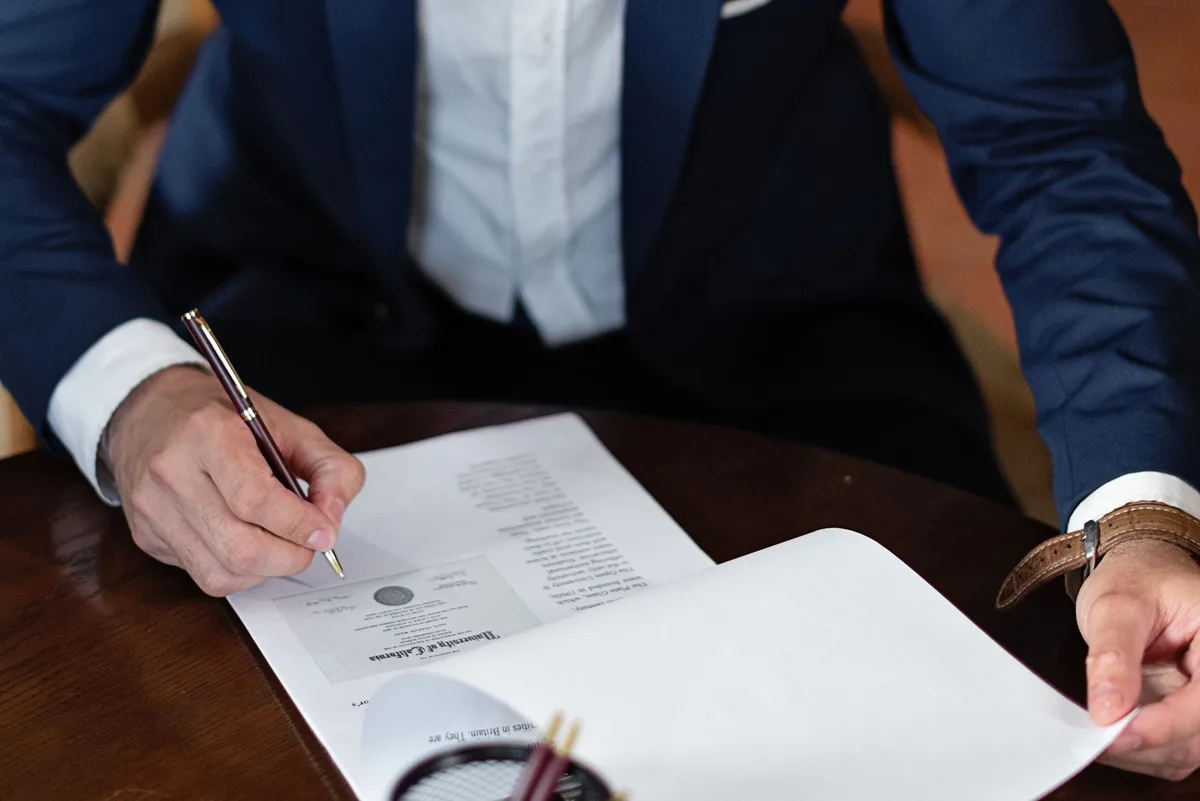 Documents and pen on desk representing legal compensation planning