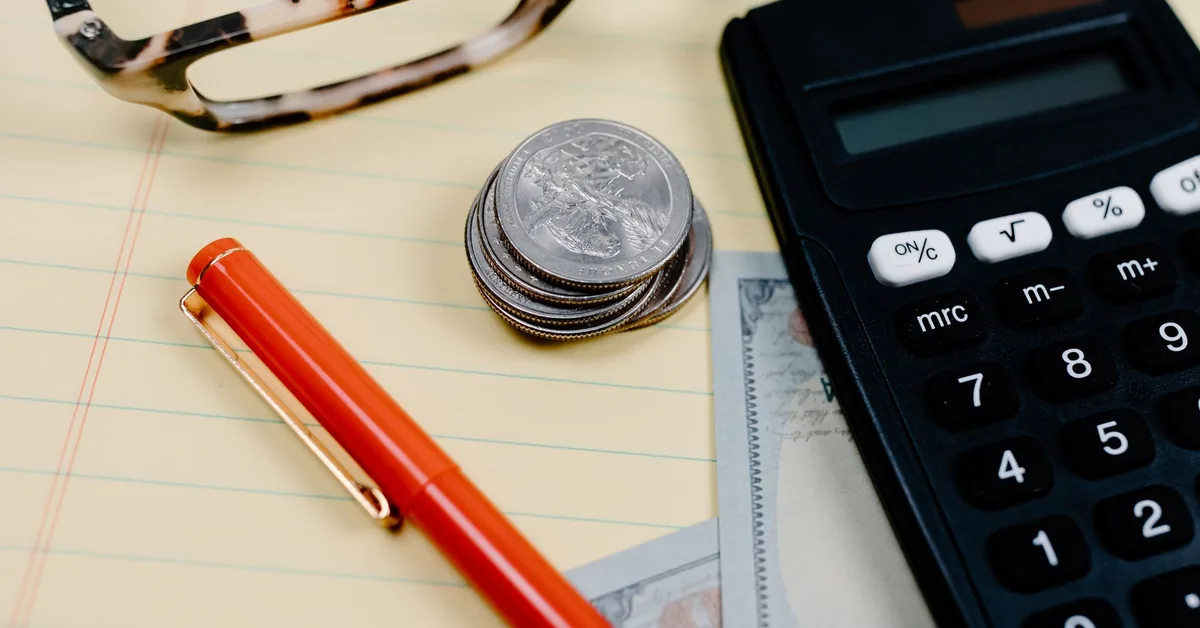 Calculator and paperwork on a desk for working out UK tax