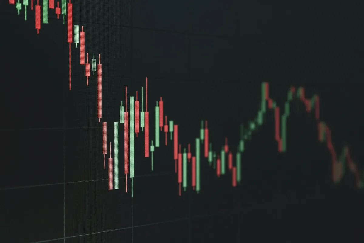 Rising bar chart on a screen representing investment growth