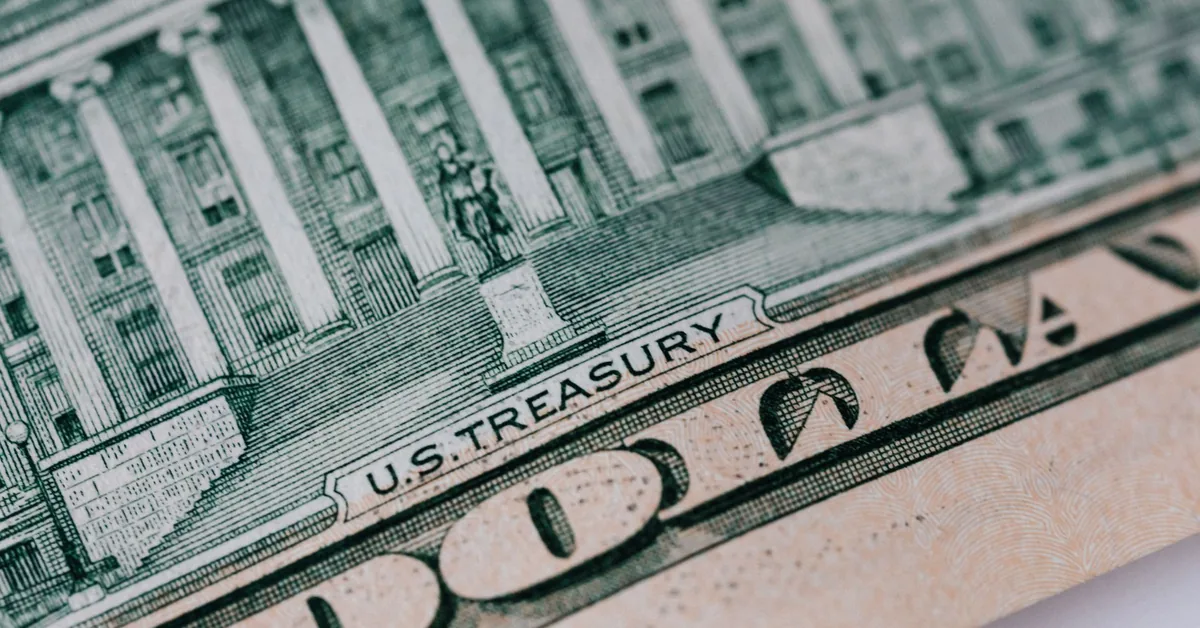 Hands organizing coins and bills representing systematic savings and fixed-income investing strategy
