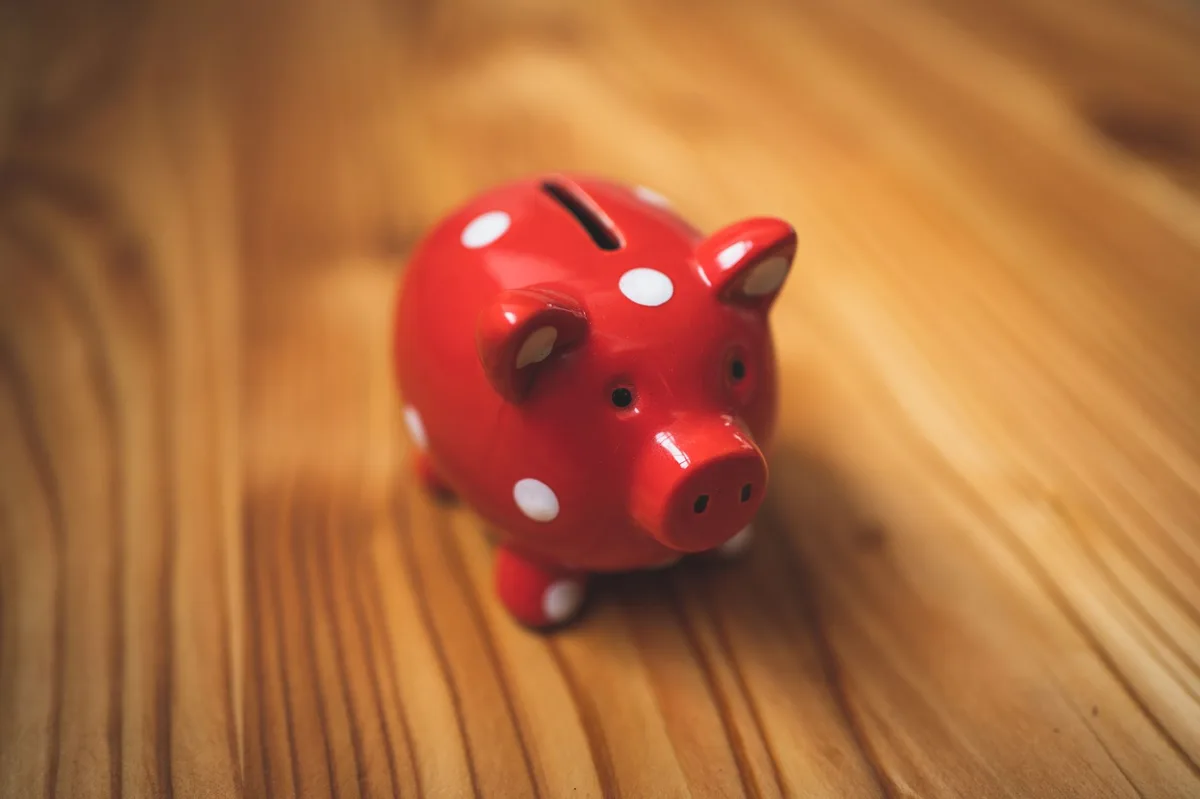 Piggy bank with stacked coins representing emergency savings planning