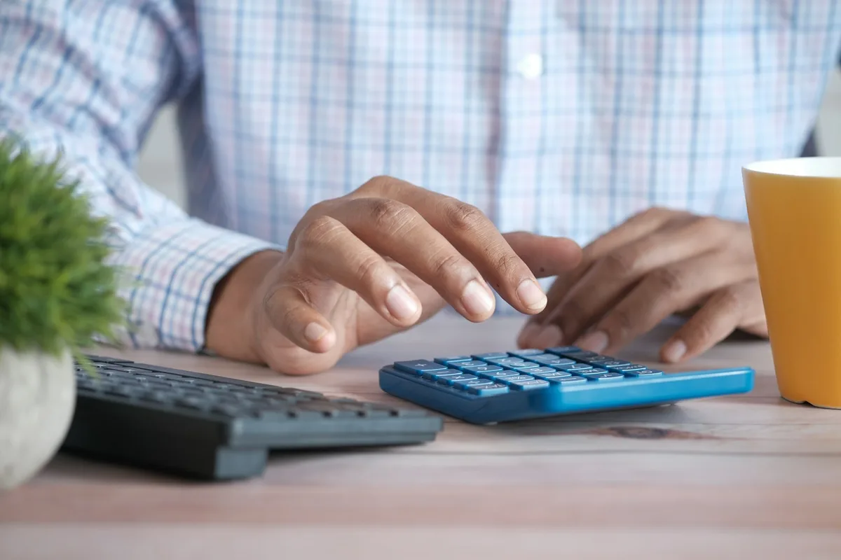 Retirement planning documents and calculator on a desk viewed from above