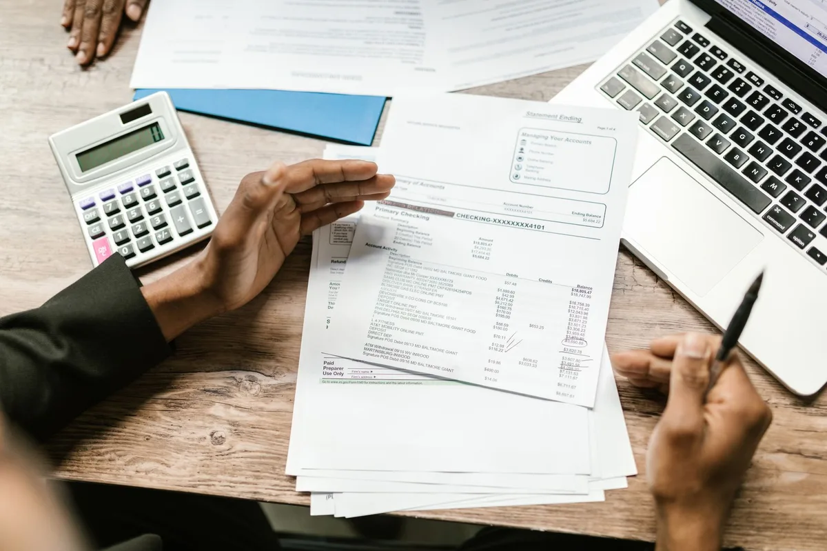 Financial planning documents and calculator on a desk from above