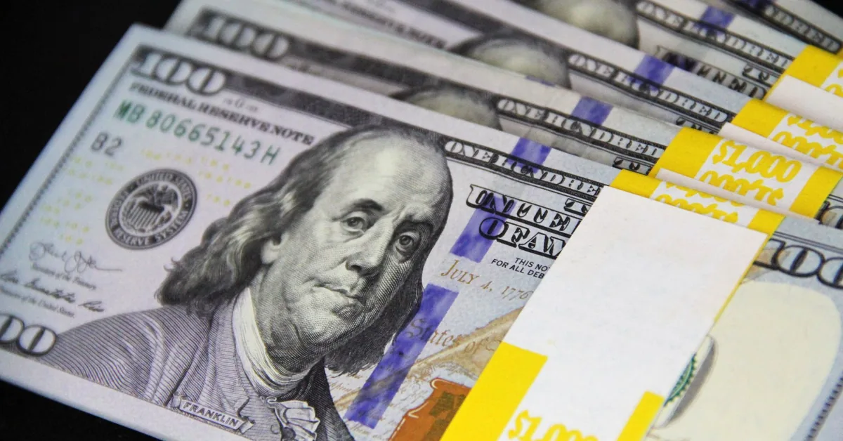 Close-up of US dollar bills used to represent savings and fixed-income investing.