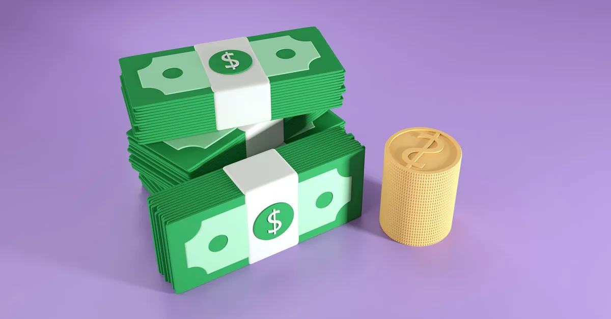 US dollar bills arranged on a financial planning desk.
