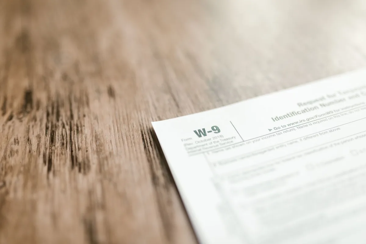 Official documents and pen on desk representing IRS correspondence and tax paperwork