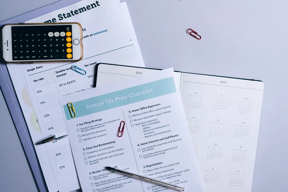 Planning desk with documents, pen, and calculator representing retirement distribution planning