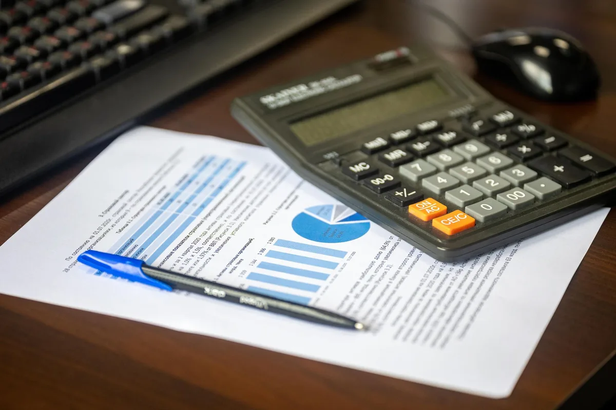 Planning documents with pen on desk representing retirement benefit calculations