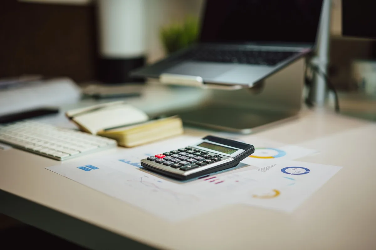 Retirement planning documents and calculator on a desk