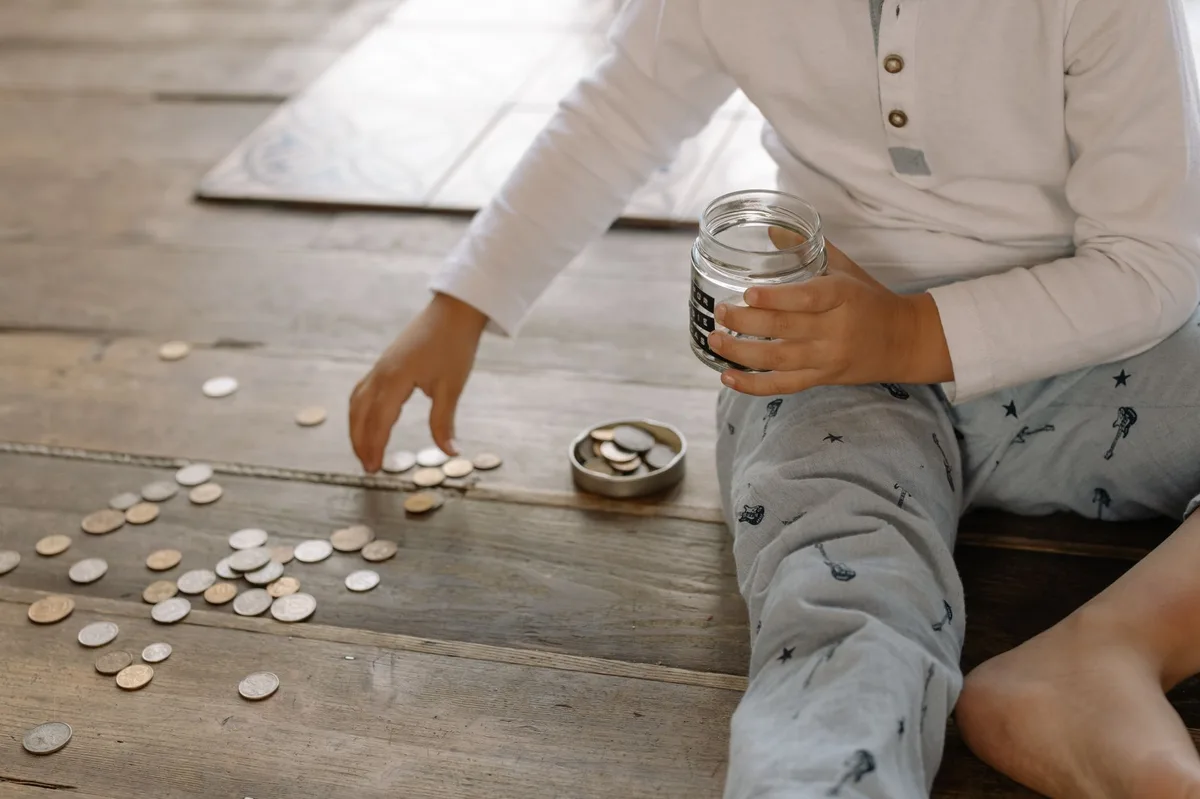 Piggy bank with stacked coins representing savings for children